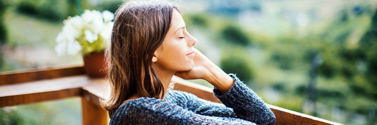 Young woman enjoying a fresh air on the mountain