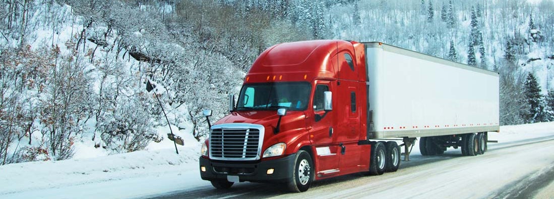 Red semi truck tractor transporting commercial cargo in refrigerator semi trailer on winter road. Find Inland Marine Insurance.