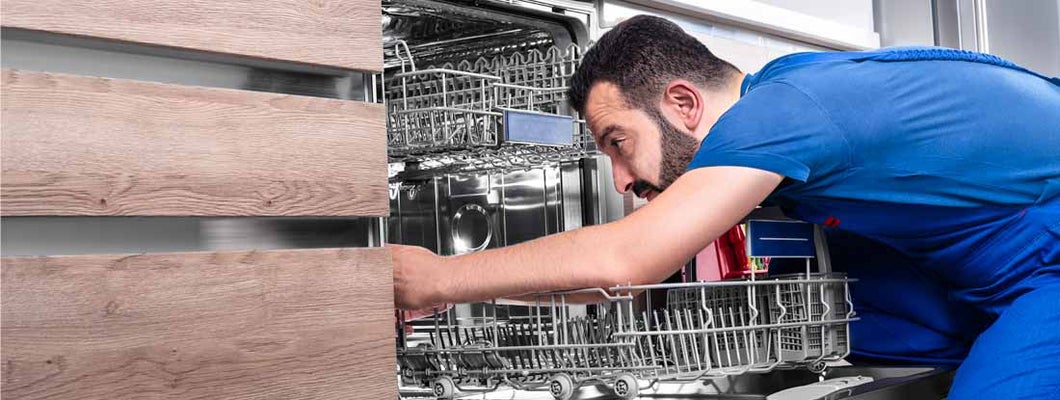 Man repairing dishwasher. Find Appliance Repair Business Insurance.
