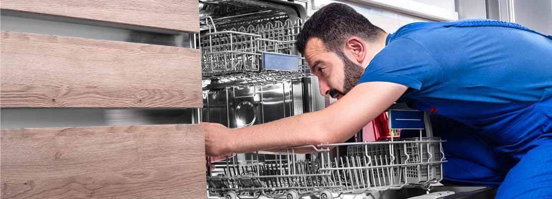 Man repairing dishwasher. Find Appliance Repair Business Insurance.