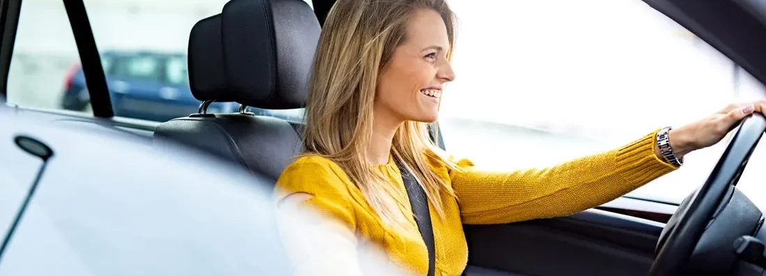 Woman driving her new car. Find Gilbert, Arizona car insurance.