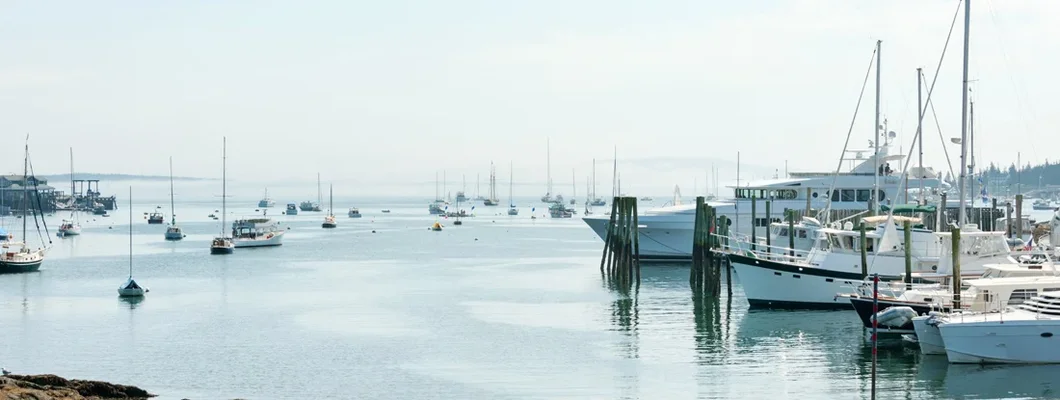 Yachts and small fishing boats in Maine marina. Find Maine Boat Insurance.