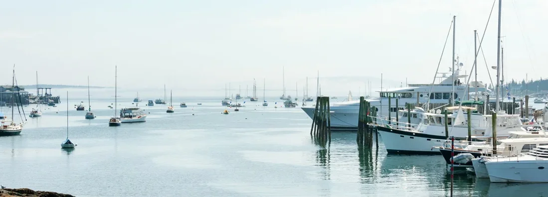 Yachts and small fishing boats in Maine marina. Find Maine Boat Insurance.