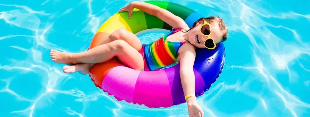 Child having fun on vacation at the swimming pool. 7 Absolutely Essential Summer Pool Safety Tips.