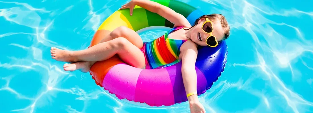 Child having fun on vacation at the swimming pool. 7 Absolutely Essential Summer Pool Safety Tips.