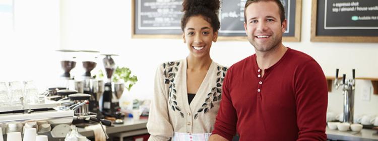 young coffee shop owners smiling.