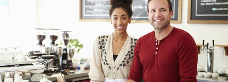 young coffee shop owners smiling.