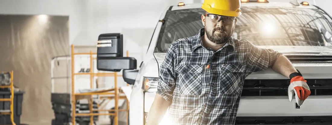 Construction Worker Chilling Out Next to His Pickup Truck. Find Commercial Pickup Truck Insurance.