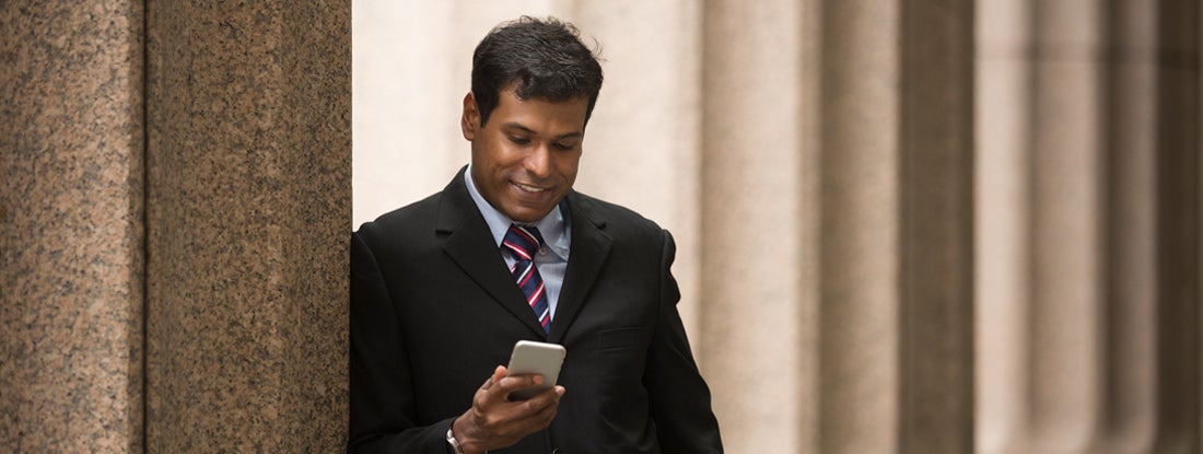 Businessman outside a colonial courthouse building.