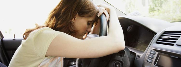 Sad woman in new car.