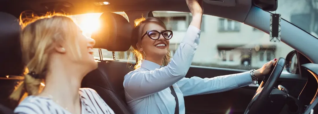 Friends enjoying road trip traveling at vacation in the car. Find Elko, Nevada car insurance.