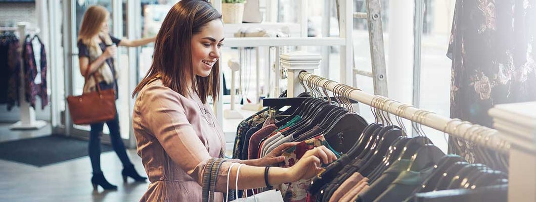 Young woman shopping at a clothing store. Find Clothing Store Insurance.