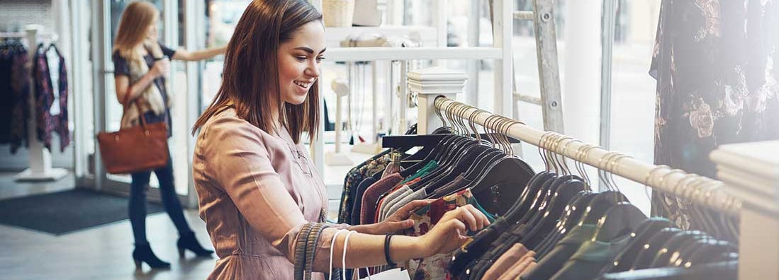 Young woman shopping at a clothing store. Find Clothing Store Insurance.