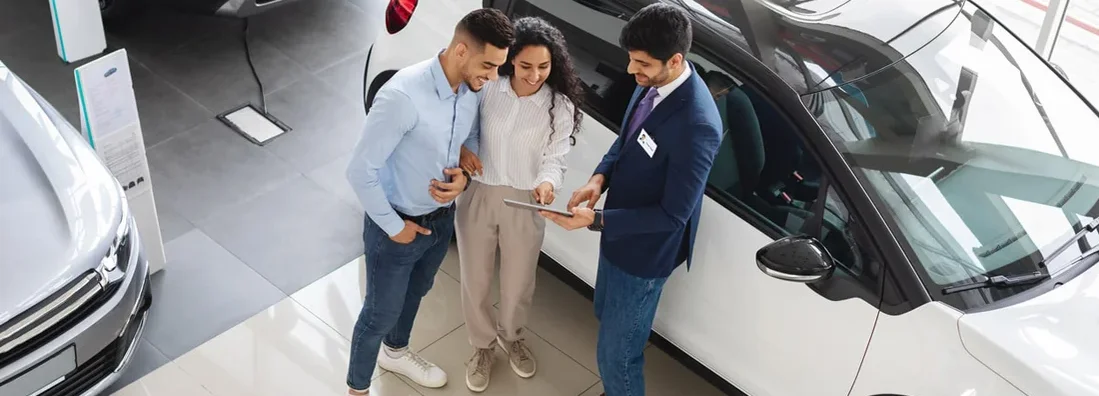 Customers having conversation with sales assistant, leasing a car. How to lease a car.