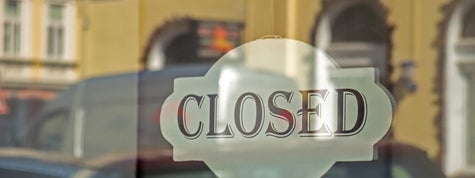 Closed sign on shop glass front door