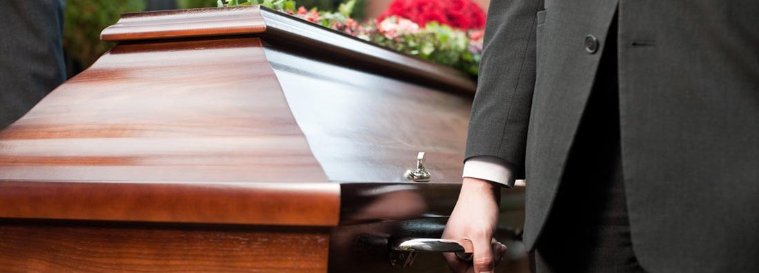 Casket carried by coffin bearer at funeral. Find Funeral Home Insurance.