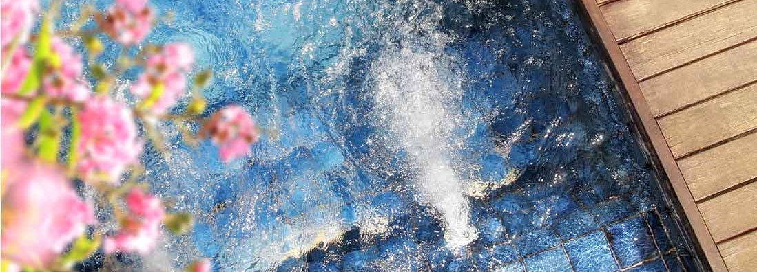 Close up outdoor hot tub with clear flowing water