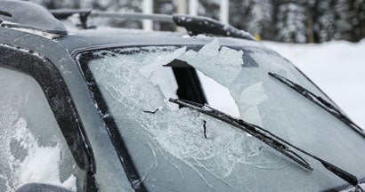 Broken windshield of a car after an accident in winter. What is Comprehensive Insurance? 