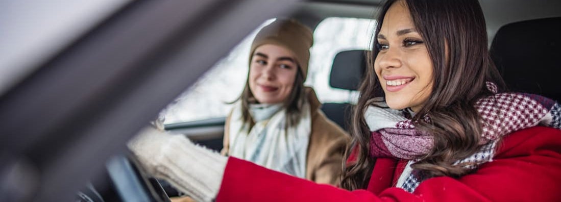Women on a winter road trip. Find Palmer Alaska car insurance.