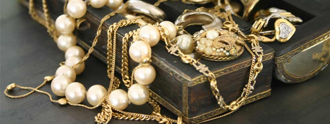 Jewelry laying over a jewelry box. Find Jewelry Store Insurance.
