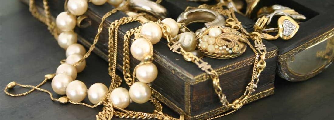 Jewelry laying over a jewelry box. Find Jewelry Store Insurance.