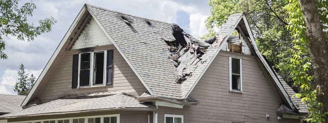 roof of a house burned and caved in