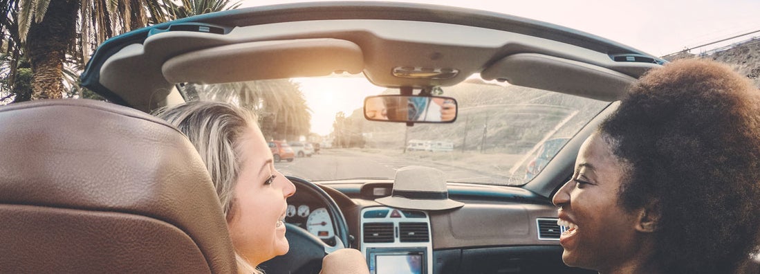 Happy girls having fun in convertible car in San Diego. Find San Diego California car insurance.