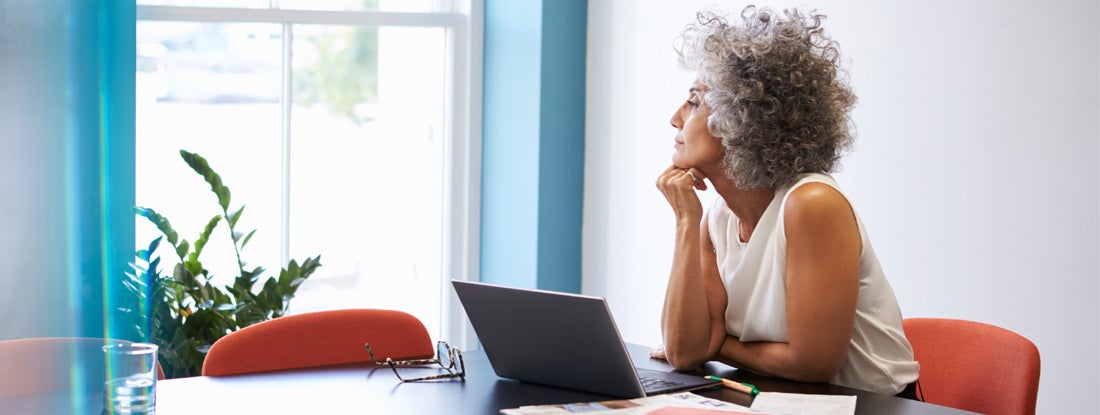 Woman looking out of the window in the boardroom