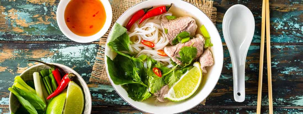 Traditional Vietnamese soup Pho bo with herbs, meat, rice noodles, broth. 