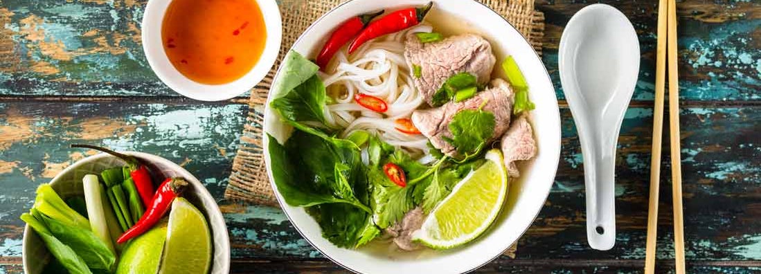 Traditional Vietnamese soup Pho bo with herbs, meat, rice noodles, broth. 