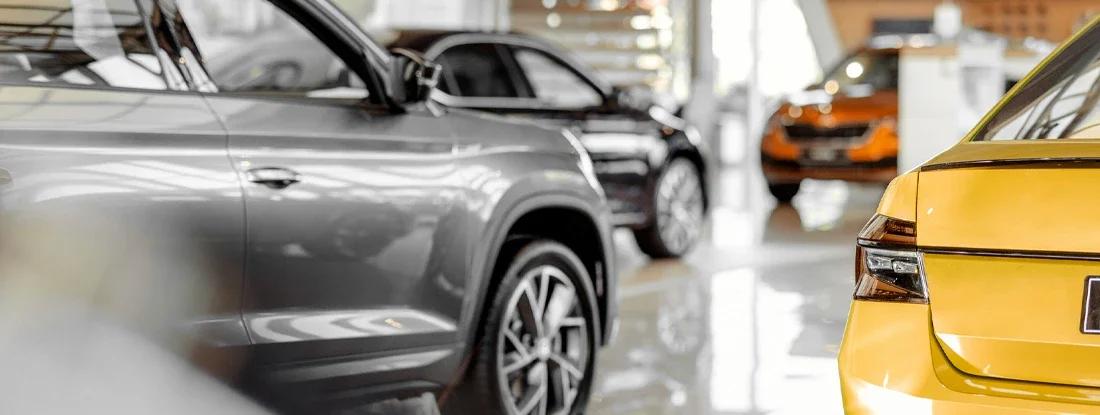 Cars parked in luxury showroom. Hybrid vs. Gas-Powered Cars: Which is Best?