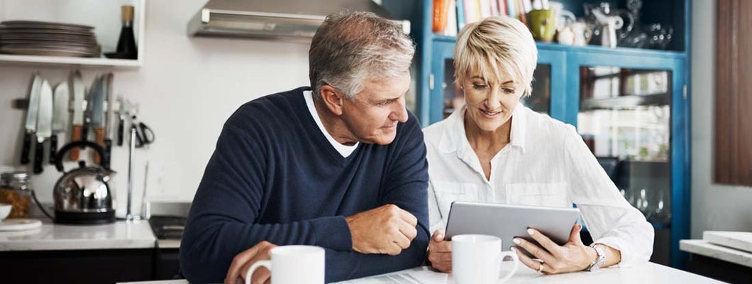 Mature couple using digital tablet to search for a pure life annuity specialist