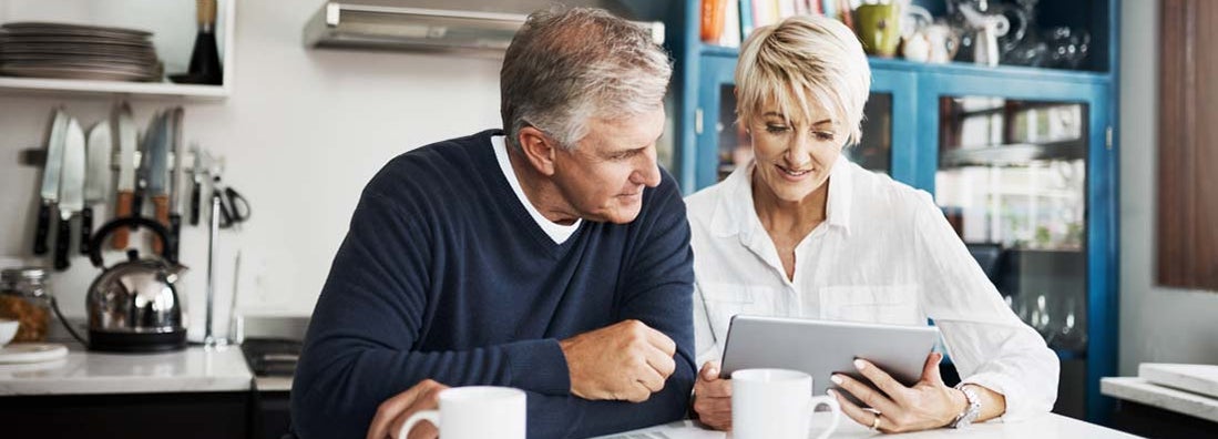 Mature couple using digital tablet to search for a pure life annuity specialist