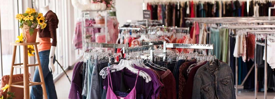 Clothes on a rack at consignment store. Find Consignment Store Insurance.