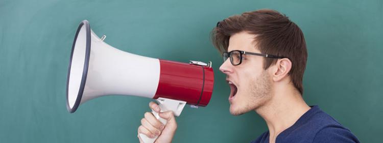 A man yelling into a megaphone.