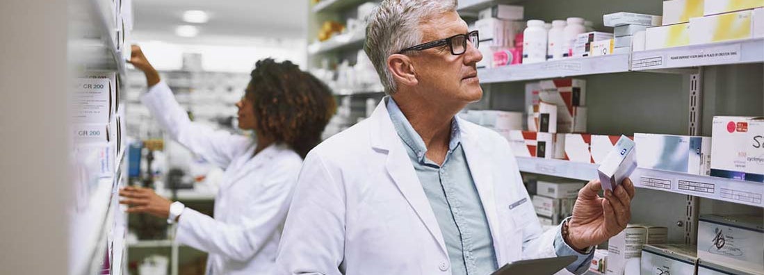 Two pharmacists taking stock inside of a pharmacy. Find medical malpractice insurance.