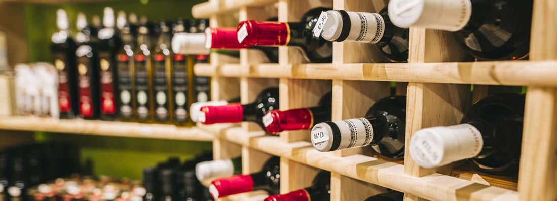 Wine bottles available for sale in a market. Find Liquor Store Insurance.