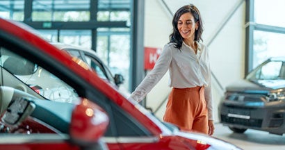 Businesswoman choosing a new car. What you should pay for a new car. 