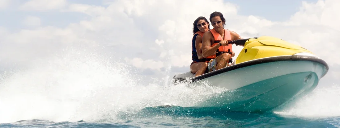 Young couple riding Jet Ski. Ride the Waves with Sit down Jet Ski Insurance.