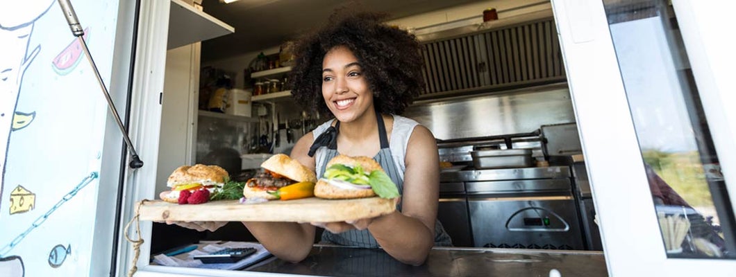 Food vendor offering sandwiches and burgers in food truck. Find Austin Texas Business Insurance.