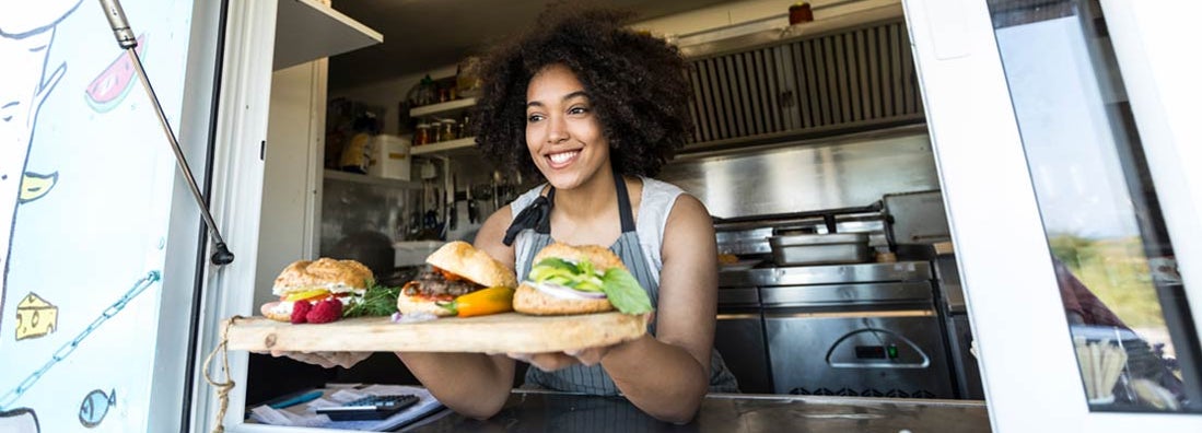 Food vendor offering sandwiches and burgers in food truck. Find Austin Texas Business Insurance.