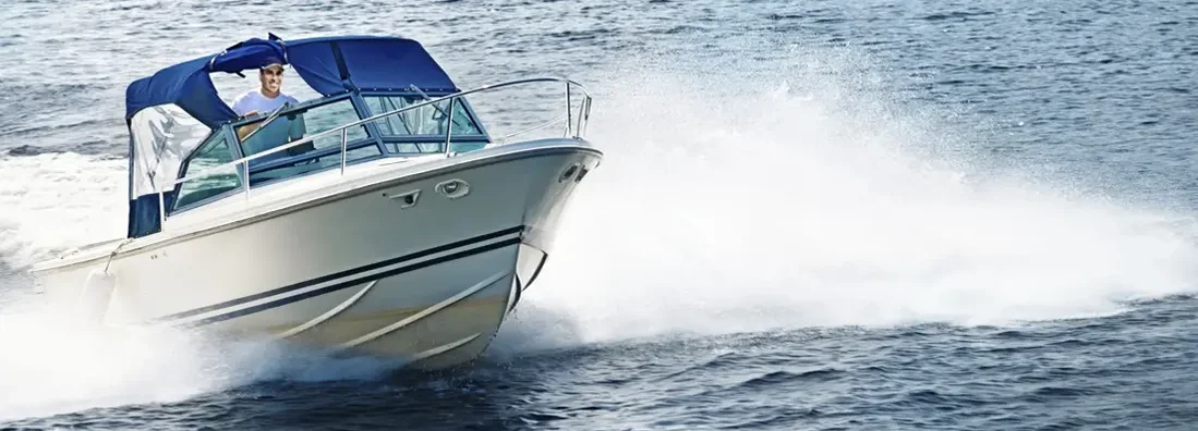 Man boating on lake. Find New York Boat Insurance.