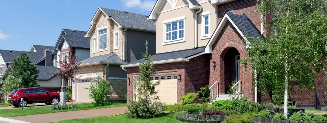 Brand new suburban houses in sunny summer afternoon. Find North Dakota umbrella insurance.