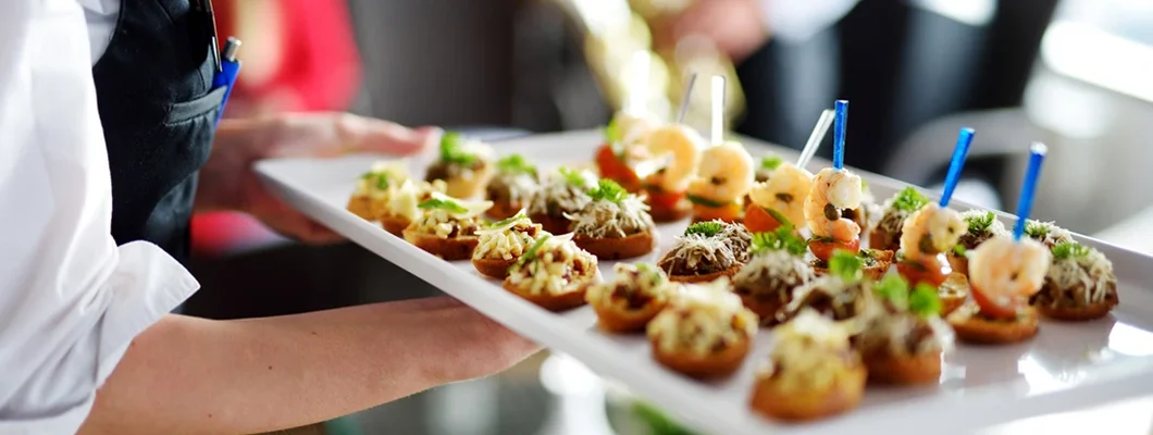 Caterer carrying plate for festive event. How to start a catering business.