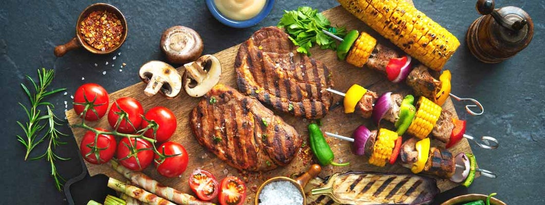 Barbecue menu. Grilled meat and vegetables on rustic stone plate