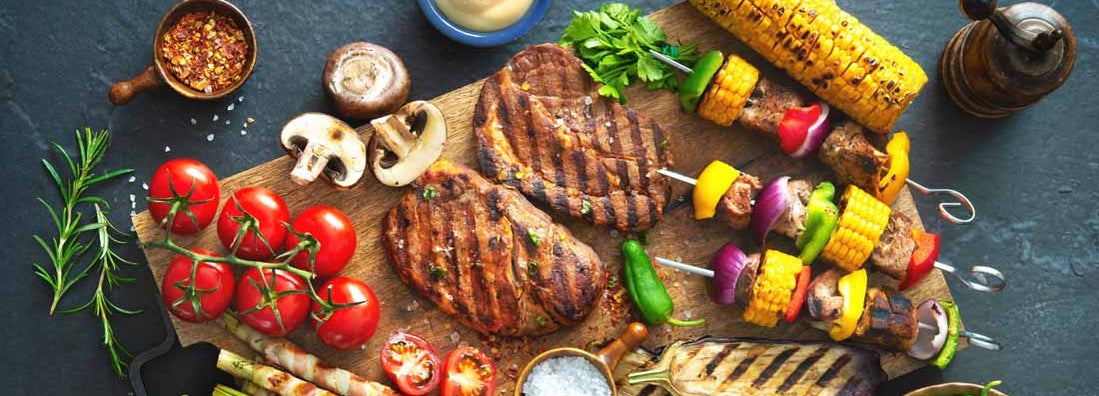 Barbecue menu. Grilled meat and vegetables on rustic stone plate