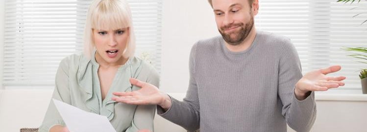 couple looking at car insurance bill