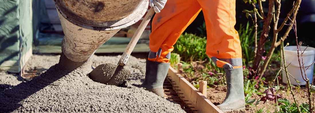 Worker spreading ready mix concrete. Find Concrete Contractors Insurance.