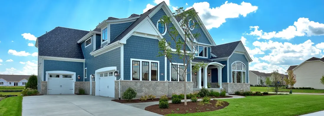 Large craftsman home with blue siding and three car garage. How to Find the Best Homeowners Insurance in Middleton, WI.