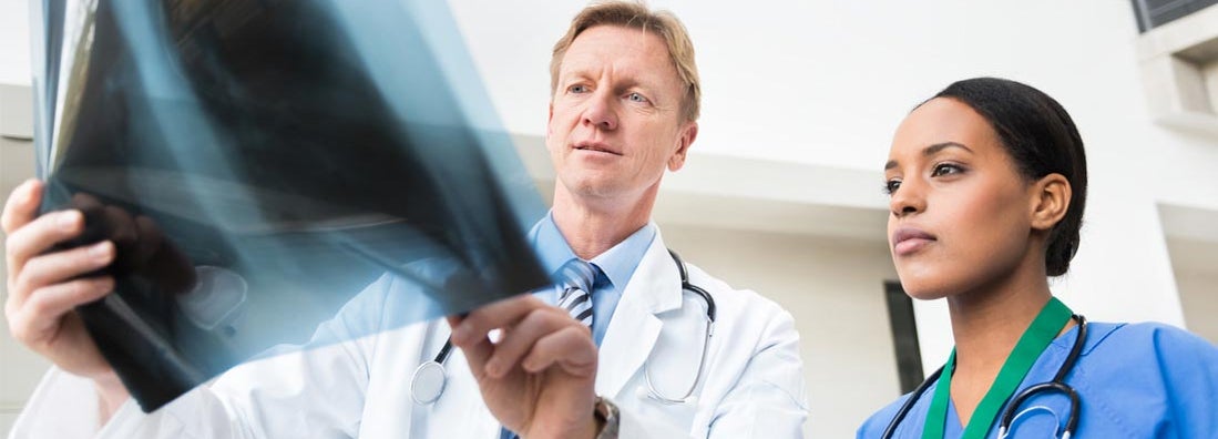 Doctors Examining X-Ray. Find Physician Assistant Insurance.